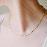 woman wearing bar bead ball chain necklace