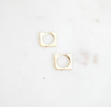 pair of gold and diamond huggie earrings
