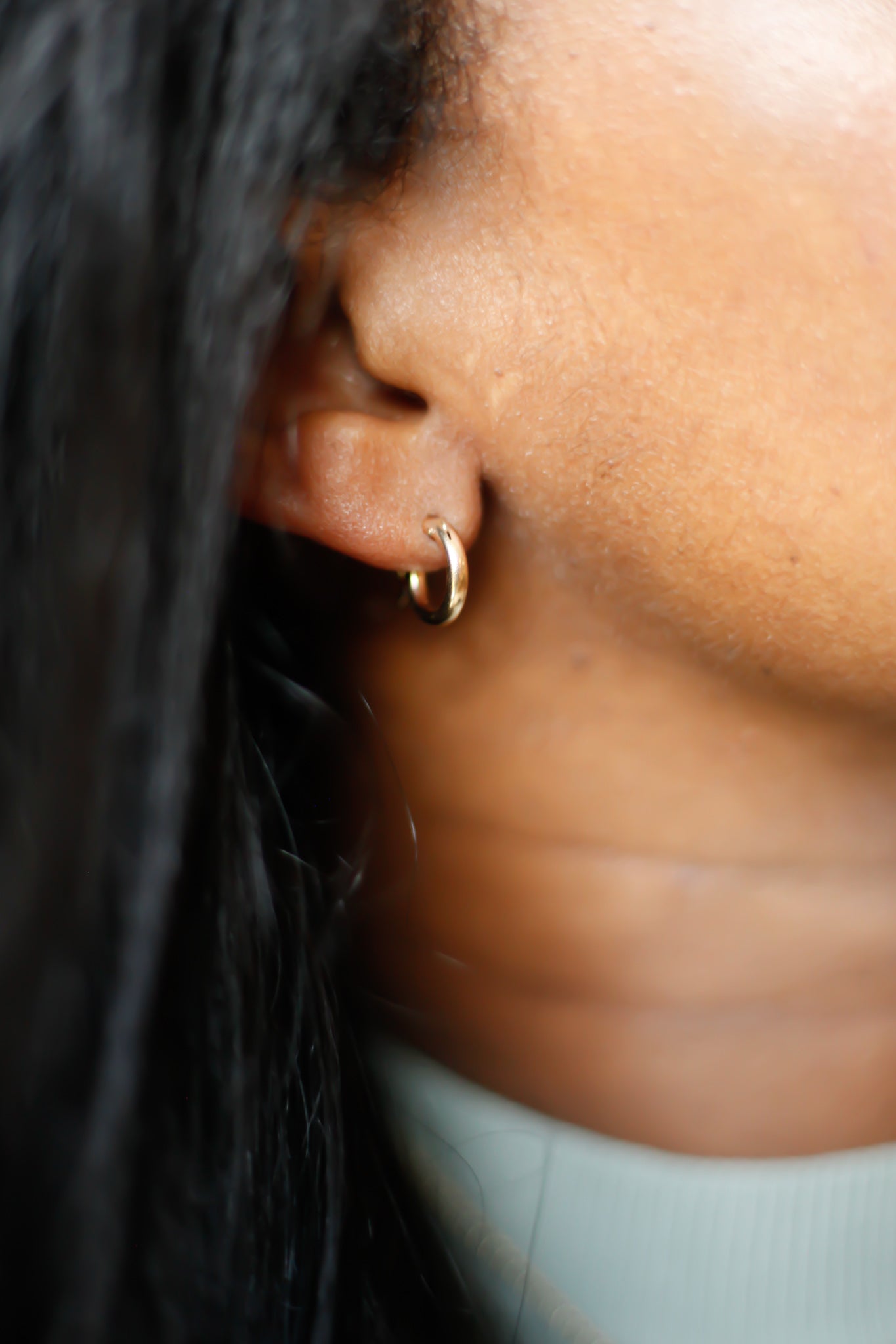 ear wearing petite gold hoop