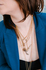 woman wearing victorian necklaces layered up