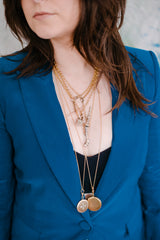 woman wearing victorian necklaces layered up