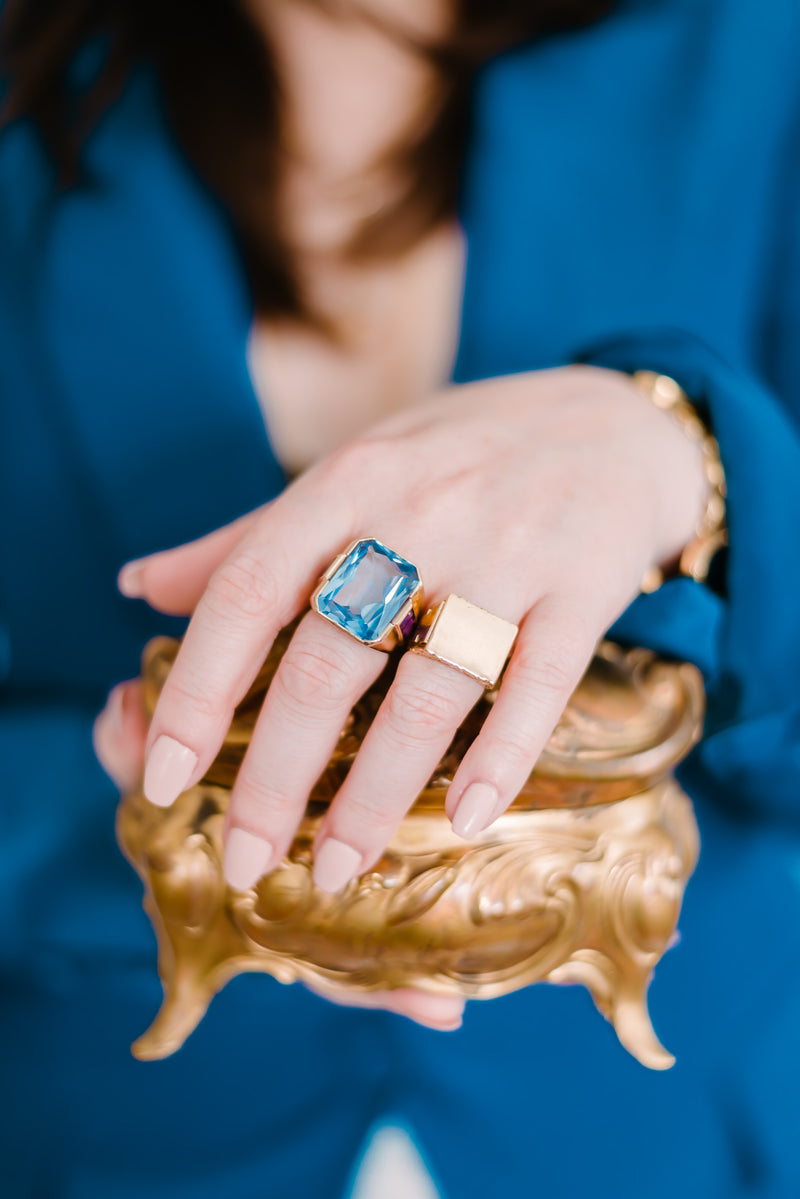 woman wearing rings with hand atop victorian jewelry box