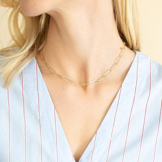 woman wearing gold paper clip chain necklace