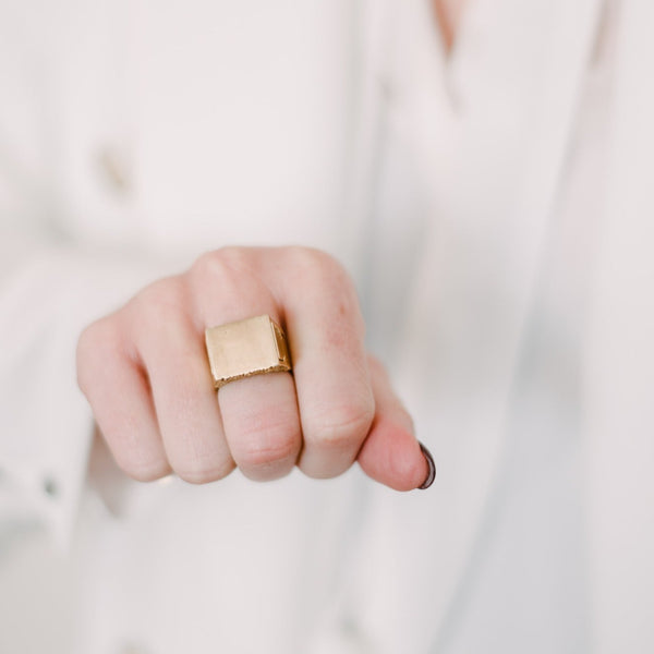 woman wearing solid brass ring with compartment