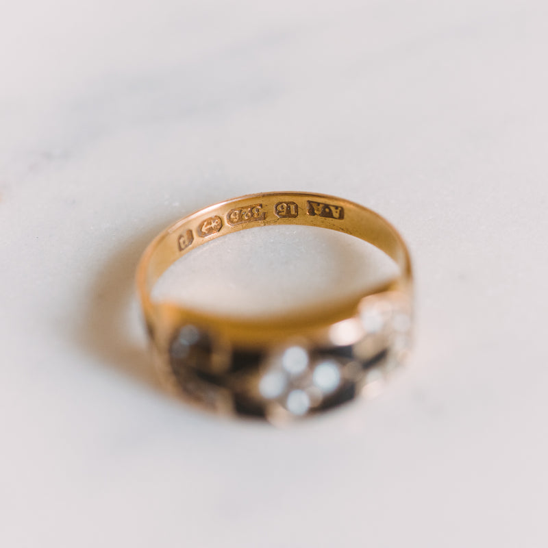 a closeup of the inscription inside a gold and onyx ring