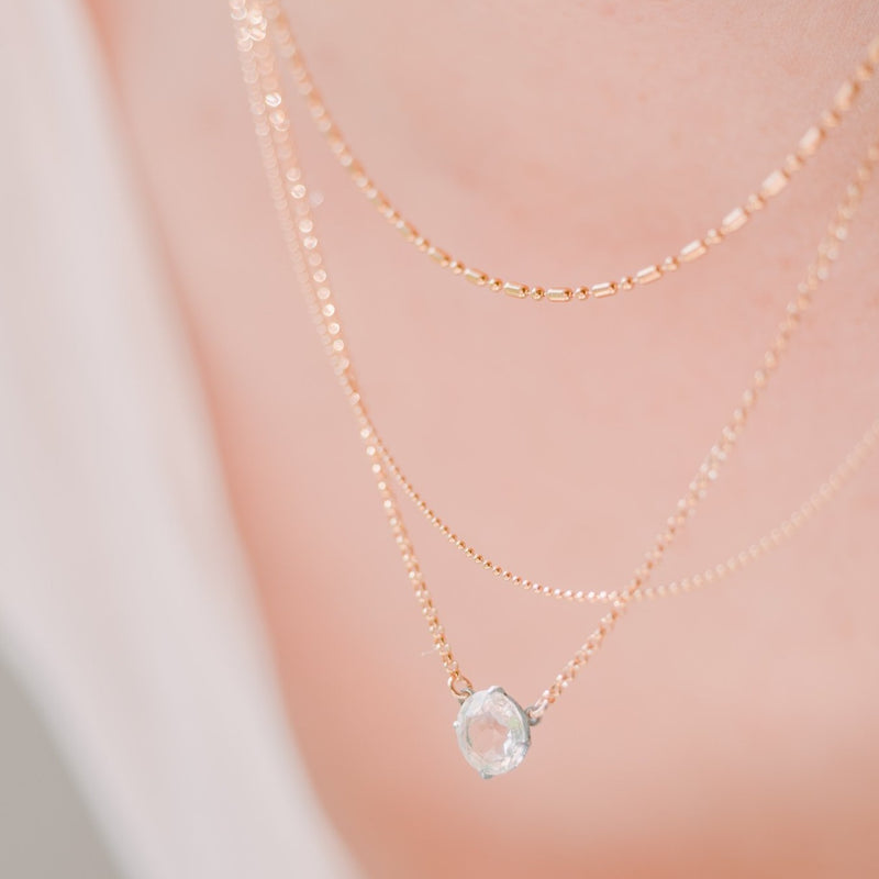 woman wearing layered necklaces