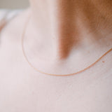woman wearing ball chain necklace