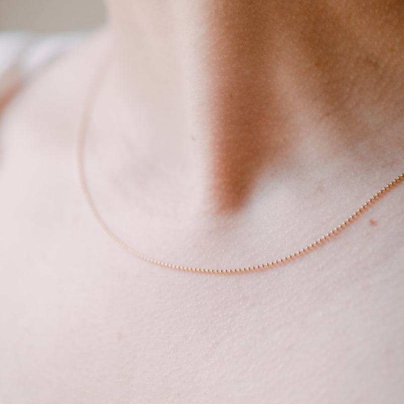 woman wearing ball chain necklace