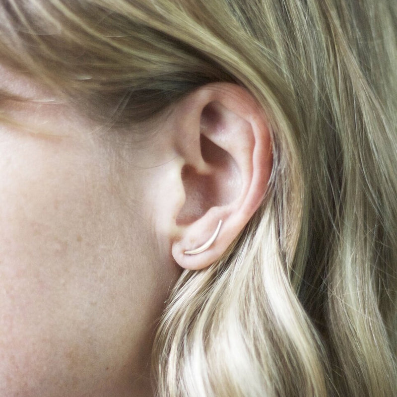 ear wearing gold crescent post earring
