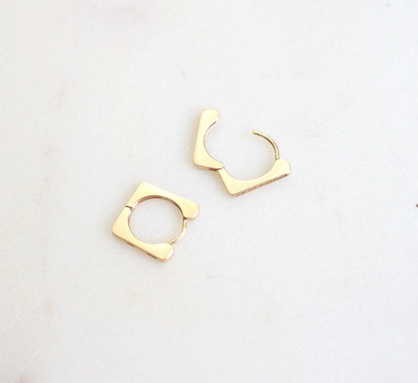 pair of gold and diamond huggie earrings