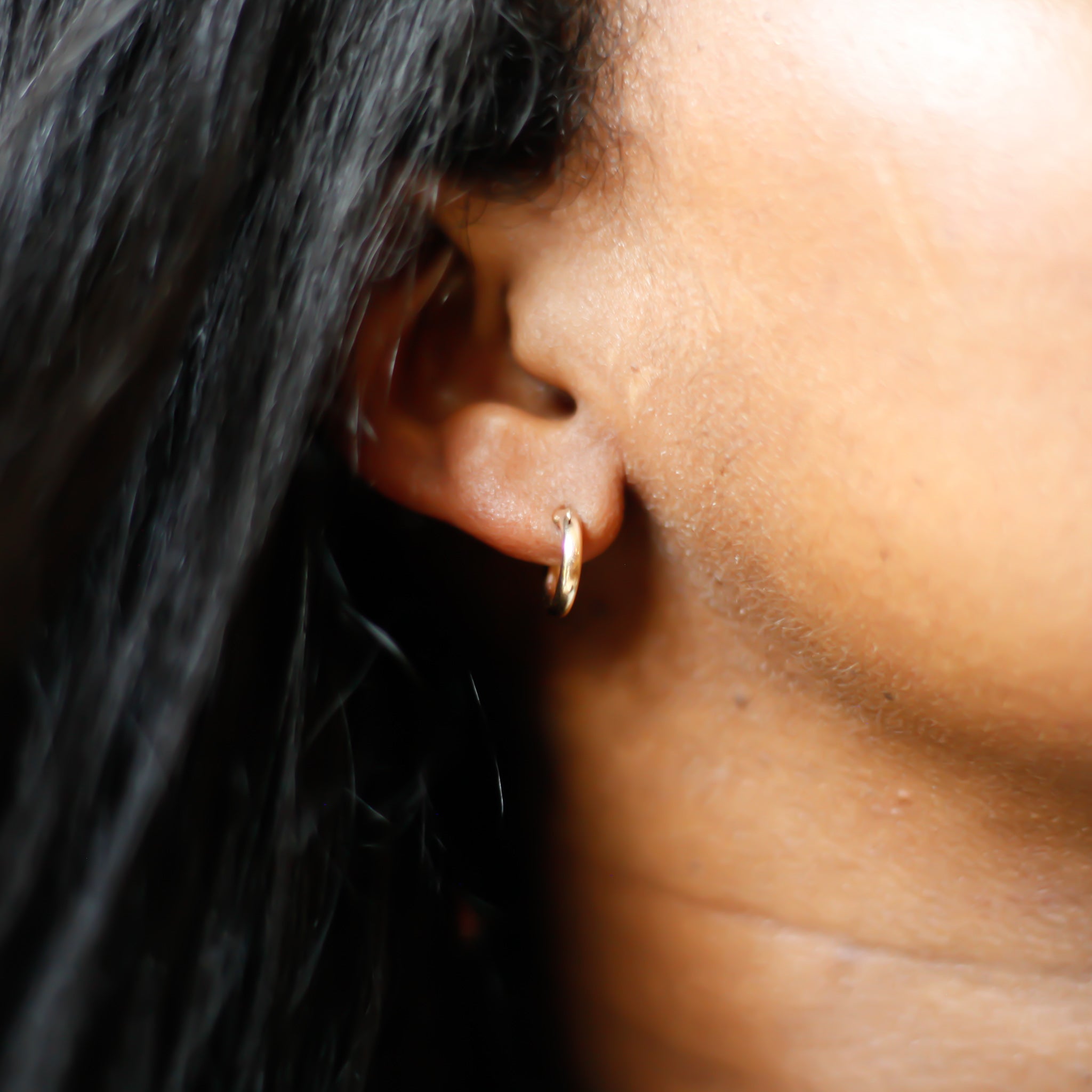 ear wearing petite gold hoop